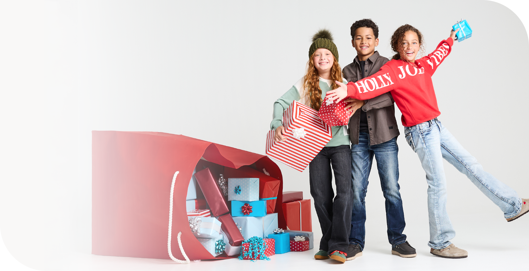A group of 3 kids wearing the latest holiday styles from Buckle Kids.